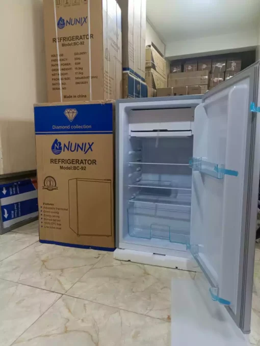 Nunix BC-92 92L Single Door Refrigerator with stainless steel finish, compact design, and adjustable thermostat.